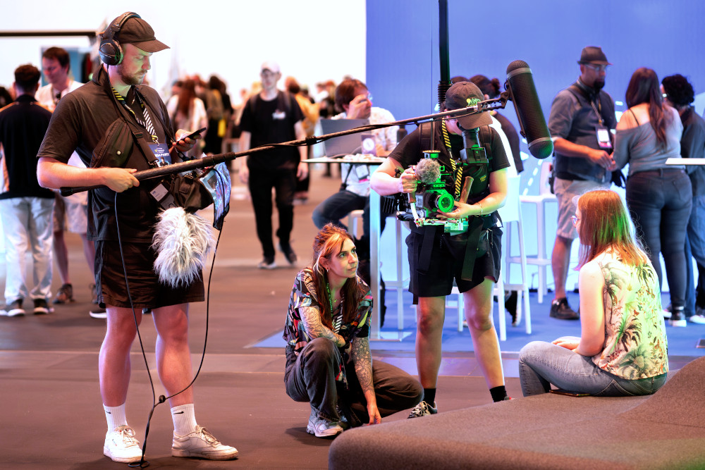 A camera team interviewing an attendee