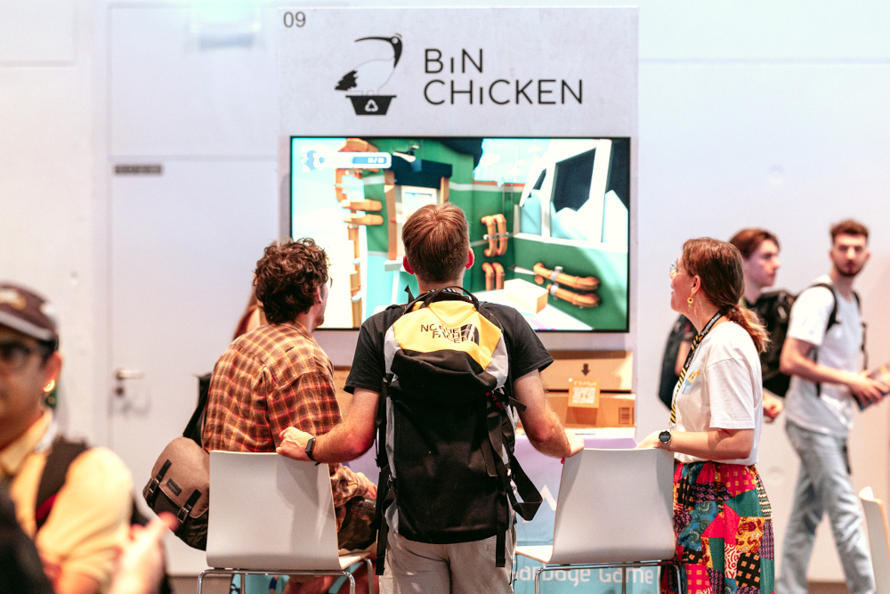 Attendees playing an indie game at an expo booth